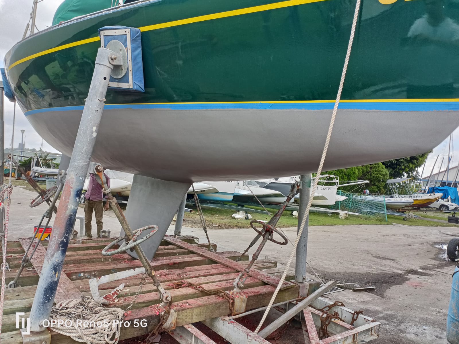 Hull and superstructure coating maintenance on yacht at waterline